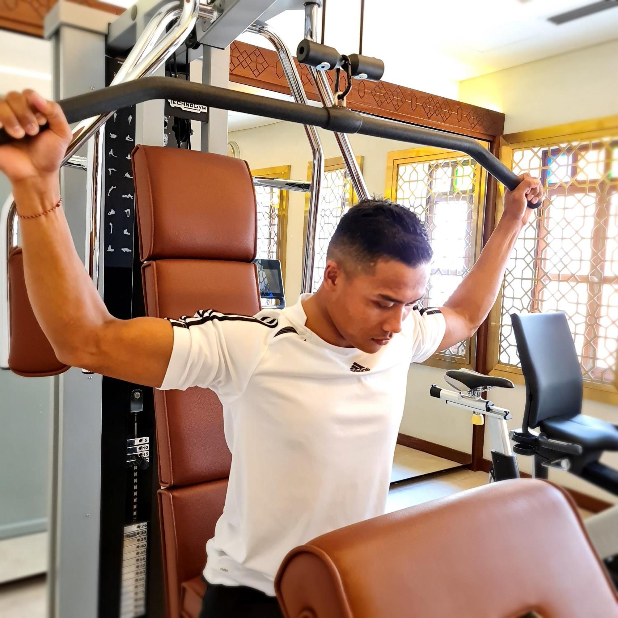 Souq Al Wakra Hotel Qatar By Tivoli Al Wakrah Exterior photo A man performing a lat pulldown